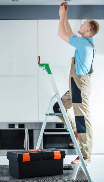 professional-electrician-on-ladder-PXJTP2G.jpg