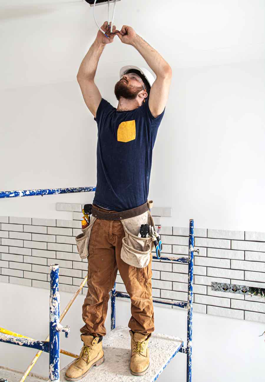 electrician-builder-at-work-installation-of-lamps-52CY9UP.jpg